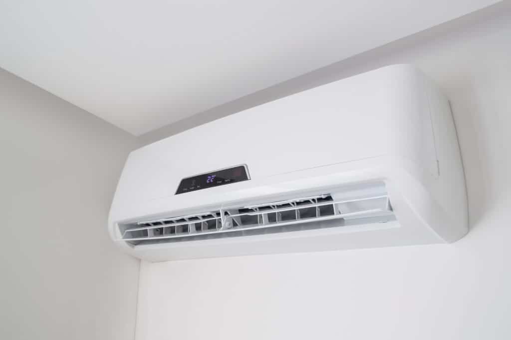 Split air conditioner on a white wall in flat indoors