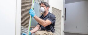 Home - Bill Howe Signs your AC needs HVAC repair -- a man inspecting the air filter.
